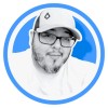 Blue circular portrait avatar of Alfonso Mujica